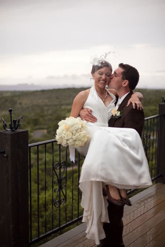 groom carrying the bride and kissing her