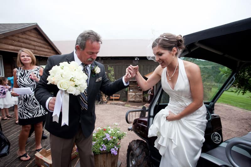 bride been held in the hand coming out of a vehicle