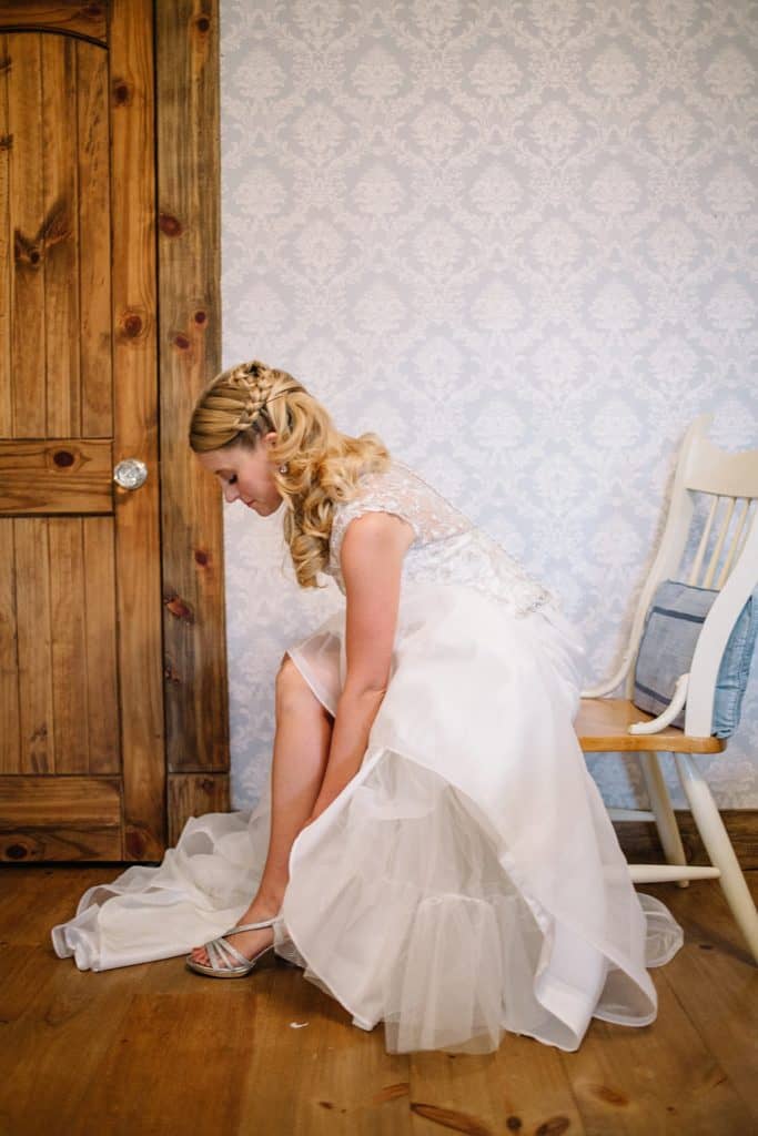a bride putting on her shoe