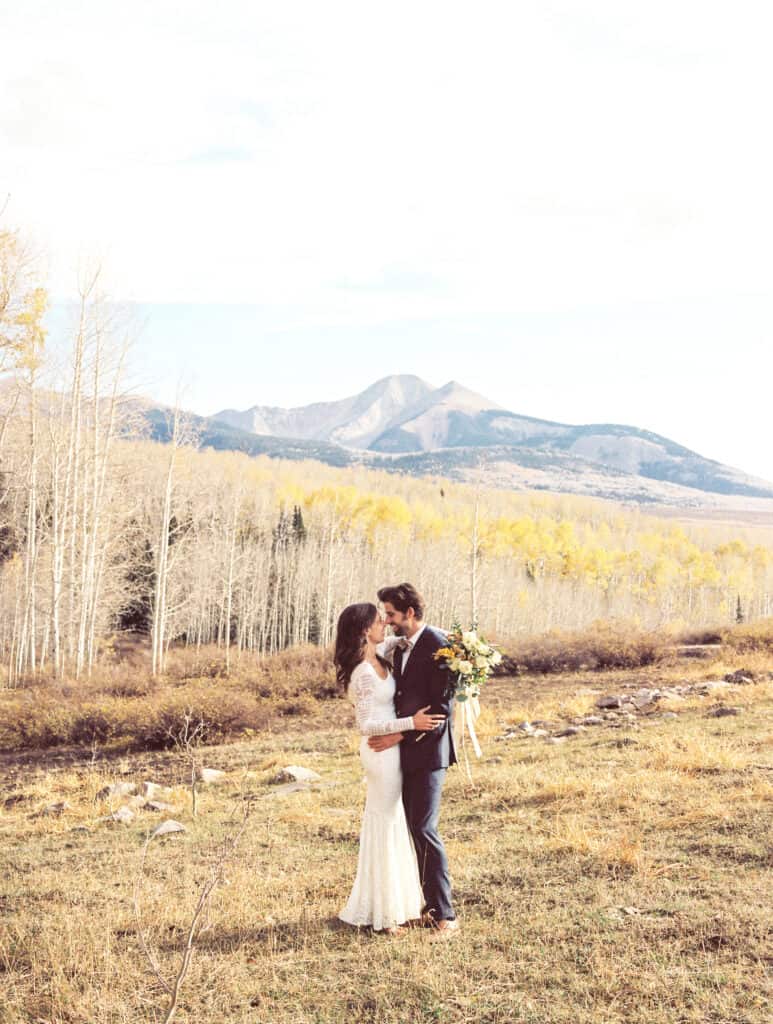 couple embracing with view of mountains